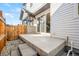 Back patio with rock detail landscaping, a fenced gate, and a sliding door to the interior at 9700 E 63Rd Pl, Denver, CO 80238