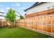Beautifully fenced backyard featuring well-manicured lawn and new landscaping at 9700 E 63Rd Pl, Denver, CO 80238