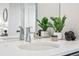 Bathroom vanity with chrome faucet, white countertop, and decor at 9700 E 63Rd Pl, Denver, CO 80238