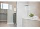 Bathroom featuring a glass shower, seat, and modern tile work at 9700 E 63Rd Pl, Denver, CO 80238