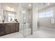 Bathroom with a glass shower enclosure, double vanity, and tile flooring at 9700 E 63Rd Pl, Denver, CO 80238