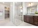 Bathroom with a glass shower enclosure and a spacious walk-in closet at 9700 E 63Rd Pl, Denver, CO 80238