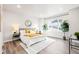 Bright bedroom with a large window, yellow-toned throw blanket, and stylish rug at 9700 E 63Rd Pl, Denver, CO 80238