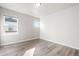 Bright, empty bedroom featuring wood-look floors, neutral walls, and natural light creating a blank canvas for personalization at 9700 E 63Rd Pl, Denver, CO 80238