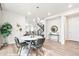 Dining room with modern chandelier, table for four and staircase in the background at 9700 E 63Rd Pl, Denver, CO 80238