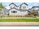 Well-manicured front yard of a new two-story home featuring craftsman style details and stone accents at 9700 E 63Rd Pl, Denver, CO 80238