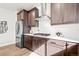 Modern kitchen features stainless steel appliances, ample counter space, and stylish dark cabinets at 9700 E 63Rd Pl, Denver, CO 80238