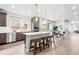 Bright, open-concept kitchen featuring an island, stainless steel appliances, and hardwood floors at 9700 E 63Rd Pl, Denver, CO 80238