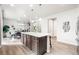 Spacious kitchen island with seating, modern lighting, and an open floor plan to dining room at 9700 E 63Rd Pl, Denver, CO 80238
