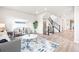 Bright living room features a modern design, hardwood floors, and neutral color palette at 9700 E 63Rd Pl, Denver, CO 80238