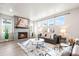 Bright living room featuring a fireplace, ample natural light, and a comfortable gray sofa at 9700 E 63Rd Pl, Denver, CO 80238