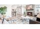 Inviting living room with a cozy fireplace, stylish rug, and comfortable seating arrangement at 9700 E 63Rd Pl, Denver, CO 80238