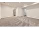 Open basement layout with neutral carpet, a doorway leading to a bathroom, and recessed lighting at 18241 E 47Th Dr, Denver, CO 80249