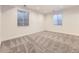 Finished basement featuring neutral carpet and two windows, offering a bright and versatile living space at 18241 E 47Th Dr, Denver, CO 80249