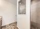 Bathroom with modern shower, tiled walls, and neutral color scheme at 18241 E 47Th Dr, Denver, CO 80249