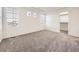 Bright bedroom with plush carpet, tray ceiling, and walk-in closet at 18241 E 47Th Dr, Denver, CO 80249