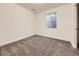 Cozy bedroom with neutral carpet and a basement window providing natural light, a simple, yet inviting space at 18241 E 47Th Dr, Denver, CO 80249