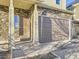 Detailed front entrance showcasing the stone facade, covered porch, and the two car garage at 18241 E 47Th Dr, Denver, CO 80249