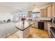 Bright open kitchen with island, stainless steel appliances, and large windows at 18241 E 47Th Dr, Denver, CO 80249