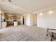 Open-concept living area featuring gray carpet and seamless flow to the kitchen at 18241 E 47Th Dr, Denver, CO 80249