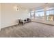 Bright living room with gray carpet, recessed lights, and natural light from many windows at 18241 E 47Th Dr, Denver, CO 80249