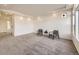 Spacious living room with gray carpet, recessed lighting, and multiple windows at 18241 E 47Th Dr, Denver, CO 80249