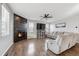 Living room with corner fireplace, hardwood floors, and comfortable seating at 5452 Juniper Dr, Brighton, CO 80601