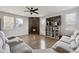 Living room features a corner fireplace, hardwood floors and comfortable seating at 5452 Juniper Dr, Brighton, CO 80601