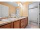 Bathroom with a double sink vanity, framed mirror, and an adjacent shower at 1929 Baguette Dr, Castle Rock, CO 80108