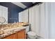 Stylish bathroom features a granite countertop vanity, modern fixtures, and a shower-tub combo at 1929 Baguette Dr, Castle Rock, CO 80108