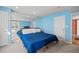 Bright bedroom with a large mirror wall and blue bed at 1929 Baguette Dr, Castle Rock, CO 80108