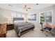 Comfortable bedroom with a large window, ceiling fan, and stylish decor at 1929 Baguette Dr, Castle Rock, CO 80108