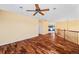 A large open space with hardwood flooring, a ceiling fan, and connections to the adjacent rooms at 1929 Baguette Dr, Castle Rock, CO 80108