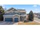 Charming two-story home with well-maintained landscaping, three car garage, and inviting front porch at 1929 Baguette Dr, Castle Rock, CO 80108