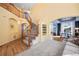 Inviting foyer with staircase, hardwood floors, carpeted living room, built-in shelving, and arched doorway at 1929 Baguette Dr, Castle Rock, CO 80108