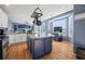 Bright kitchen featuring stainless steel appliances, island with granite countertops, and hardwood floors at 1929 Baguette Dr, Castle Rock, CO 80108