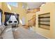 Bright living room with two-story ceilings, a staircase, and a dedicated office space with large window at 1929 Baguette Dr, Castle Rock, CO 80108