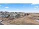 A scenic street view shows a row of beautiful homes on a sunny day with a field in the background at 1929 Baguette Dr, Castle Rock, CO 80108