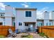 Backyard features a patio set, a grill, rock landscaping, and a wooden fence for privacy at 9155 W Portland Ave, Littleton, CO 80128