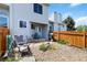 Backyard with a patio, grill, rock landscaping, and a wooden privacy fence; chair in view at 9155 W Portland Ave, Littleton, CO 80128