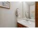 Cozy powder room with a single sink vanity and tasteful decor at 9155 W Portland Ave, Littleton, CO 80128