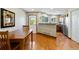 Dining area with wood table and chairs, adjacent to an open kitchen with stainless steel appliances at 9155 W Portland Ave, Littleton, CO 80128