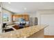 Bright kitchen with stainless steel appliances, oak cabinets, and granite countertops at 9155 W Portland Ave, Littleton, CO 80128
