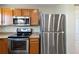 Stainless steel appliances including range, microwave and refrigerator give a contemporary look at 9155 W Portland Ave, Littleton, CO 80128
