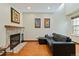 Living room with a stone fireplace, wood floors, and a comfortable couch, perfect for relaxing at 9155 W Portland Ave, Littleton, CO 80128