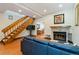 Spacious living room featuring wood floors, a stone fireplace, and an open floor plan at 9155 W Portland Ave, Littleton, CO 80128
