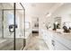 Bright bathroom featuring a soaking tub with shower, and modern fixtures at 5088 S Quail St, Littleton, CO 80127