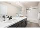 Well-lit bathroom with a sleek vanity, ample counter space, and a shower-tub combo at 5088 S Quail St, Littleton, CO 80127