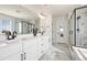 Luxurious bathroom with double vanity, sleek mirrors, and a glass-enclosed shower at 5088 S Quail St, Littleton, CO 80127