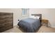 Basement bedroom features a large dresser and egress window at 5088 S Quail St, Littleton, CO 80127